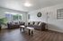 Bright and welcoming living room with cozy sofas, modern decor, and large windowed views.