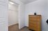 Inviting walk-in closet and elegant wooden dresser, perfect for stylish storage solutions.