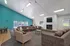 Spacious and inviting living area with vibrant turquoise accent wall, modern fireplace, and comfortable seating ideal for relaxation.