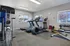 Bright and inviting gym with modern equipment including treadmills, elliptical, and free weights, ideal for fitness enthusiasts.