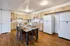 Inviting kitchen space with modern cabinetry, dual refrigerators, and a cozy dining area perfect for gatherings.