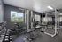 Modern fitness center with state-of-the-art weight machines, bright windows, and sleek design, perfect for a comprehensive workout experience.