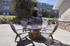 Charming apartment outdoor space featuring a cozy fire pit surrounded by comfortable seating, perfect for relaxing and entertaining.
