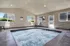 Inviting indoor spa area with bubbling jacuzzi, modern lounge chairs, and bright windows providing natural light.