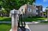 Charming apartment complex with lush green lawns and a modern car charging station, offering an eco-friendly living environment.