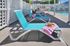 Inviting poolside area with vibrant turquoise lounge chairs, perfect for relaxation in the sun, complemented by a pink-striped towel and a summer hat.