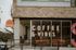Inviting coffee shop with modern glass frontage and welcoming signage.