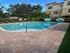 Inviting outdoor pool area with stylish lounge chairs and lush greenery, perfect for relaxation and leisure.