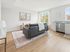 Bright and modern living area with sleek furniture, large windows, and a cozy kitchen, perfect for urban living.