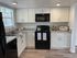 Updated Kitchen w/white cabinets and black appliances