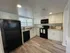 Updated Kitchen w/white cabinets and black appliances