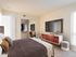 Bedroom with wall to wall carpet, large picture window