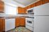 Standard kitchen with white appliance, window in kitchen