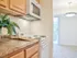 Applegate Apts; Interior, kitchen, electric range, microwave with vent, dining room with ceiling light fixture