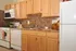 Kitchen with updated white appliances, gas range, dishwasher, frost free fridge