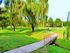 Belmont Park Apts; Exterior, grassy area, playground, benches, trees, brook with bridge
