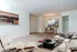 Living/Dining room full carpet, coat closet, dining room chandelier, wall cut out for kitchen