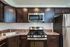 Stainless steel kitchen appliances. updated dark cabinets.