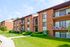 Caton House Apts, Exterior, Building entry, 3 story building, large balconies, landscaped lawn, shrubs, and trees
