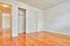 bedroom with hardwood floors and closet along wall