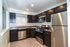 Stainless steel kitchen appliances. updated dark cabinets. wall cut out to living room