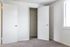 Bedroom with wall to wall carpet and walk-in closet
