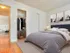 bedroom with hardwood floors and closet along wall