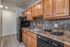 Kitchen fully updated with black appliances (gas range, dishwasher, microwave, fridge)