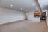 Living room, breakfast bar, and kitchen with updated black appliances