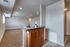 Breakfast bar and living room space with wall to wall carpet
