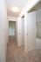 Carpeted Hallway with linen closet, doorway to smaller and master bedroom