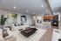 Living room, breakfast bar, and kitchen with updated black appliances