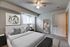 Bedroom with wall to wall carpet, 2 closets along the wall