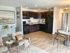 Open kitchen, wood flooring, dark cabinets