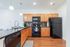 Large Kitchen. Black Appliances.