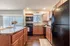 Open Kitchen with Island, Black Appliances and Plenty of Cabinetry