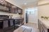 Renovated Kitchen with Black Appliances and Premium Wood Flooring