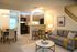 Living room dining room. Kitchen with bar stools. Sightline to patio.