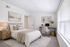Bedroom with beige accents, plants, night stand, desk