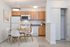 Kitchen dining space. table and 4 chairs. white appliances, maple cabinets.