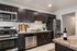Kitchen with espresso cabinetry and stainless steel appliances