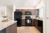 Kitchen with espresso cabinets, black appliances, island