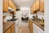 Galley style kitchen with modern dining area