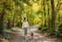Walking Trail. Woman walking dog.