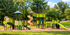 Park Crescent Apartments outdoor playground with slides, climbing structures, and grassy surroundings