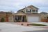 A yellow, two-story house with a gravel front yard.  | Military-Friendly Rental Houses Colorado Springs, CO