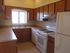 A kitchen with light cabinets and appliances. | Soaring Heights Communities Rental Houses, Alamogordo, NM