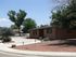 A single-story, red home with a rock yard. | Holloman AFB, Alamogordo, NM