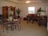 A spacious living room with brown couches and other furnitue. | Alamogordo, NM