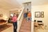 Interior of Home | Woman at bottom of stairs | 3 children sitting on stairs